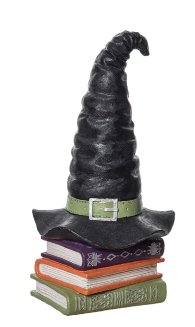 Witch hat and books decoration on a white background