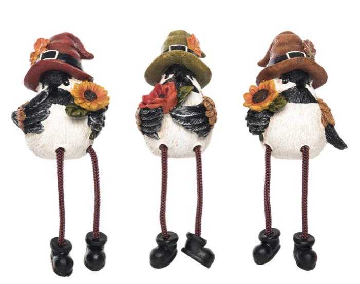 Three decorative birds with pilgrim hats and sunflower wreaths on a white background