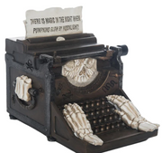 Decorative Halloween-themed typewriter with a quote on a white background