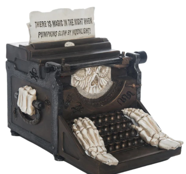 Decorative Halloween-themed typewriter with a quote on a white background