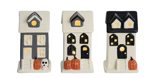Set of Halloween-themed mini houses with pumpkins and ghosts, displayed both individually and in a box.