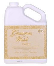 A white bottle of Trophy - Glamorous Wash laundry detergent with a label featuring intricate gold patterns and text detailing the product name and size.