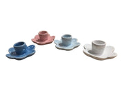 Set of four ceramic cup holders in different colors on a white background