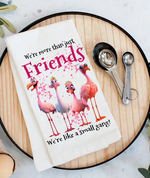 Floral-themed towel with flamingo design and text on a wooden surface