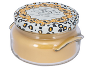 Glass jar candle with decorative lid on a white background