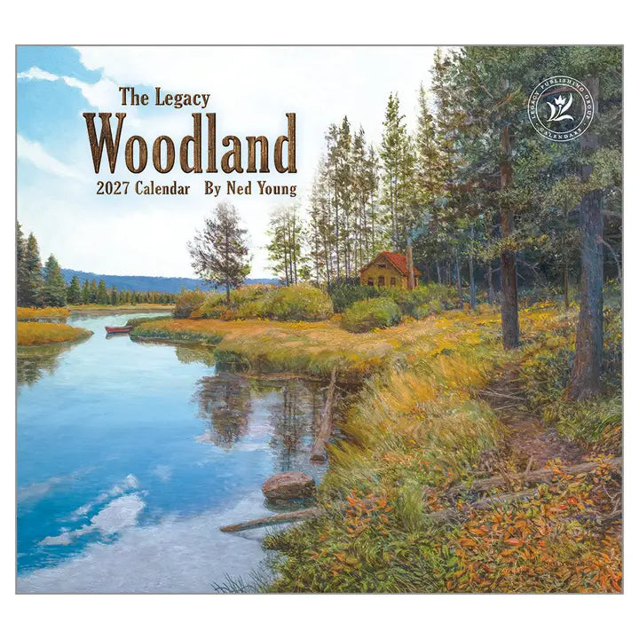 Woodland scene with a cabin by a lake, featuring the 'The Legacy Woodland' 2027 calendar by Ned Young.
