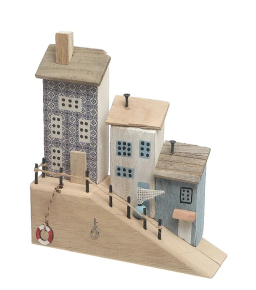 Wooden model of a small town with buildings and a street.