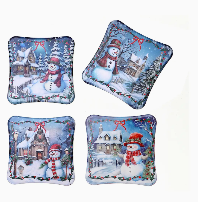 Four decorative pillows with winter scene and snowman design on a white background
