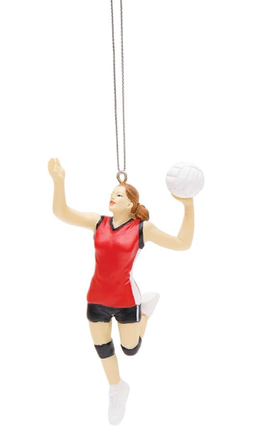 A resin ornament in the shape of a female volleyball player in red and black attire, jumping to spike a volleyball.