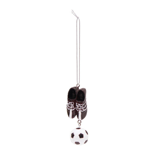 Decorative ornament with black shoes and a soccer ball on a white background