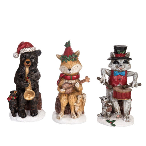 Three festive animal figurines: a bear, fox, and raccoon playing musical instruments on a white background.