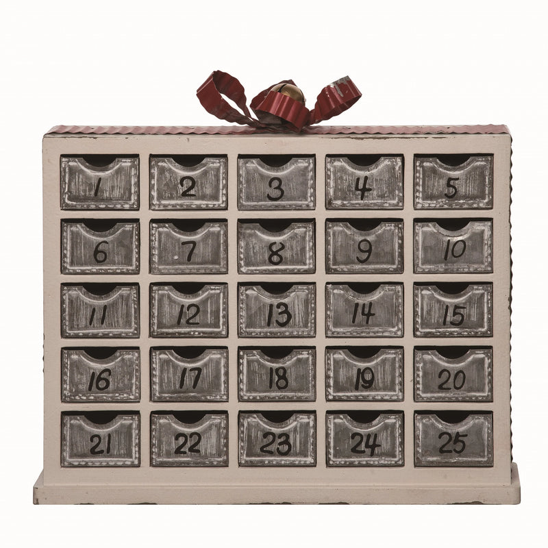 Advent calendar with numbered drawers and a ribbon on top against a white background