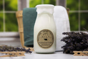 Bottle of Mile End Soap Company soap with a label on a table outdoors.