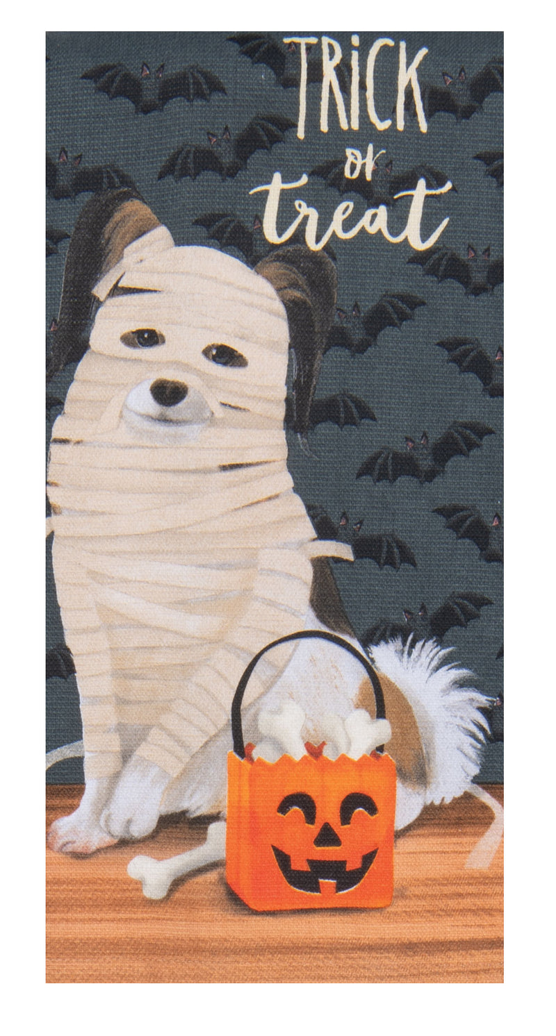 Halloween-themed towel with a mummy-wrapped dog and trick-or-treat bag on a dark background with bats.