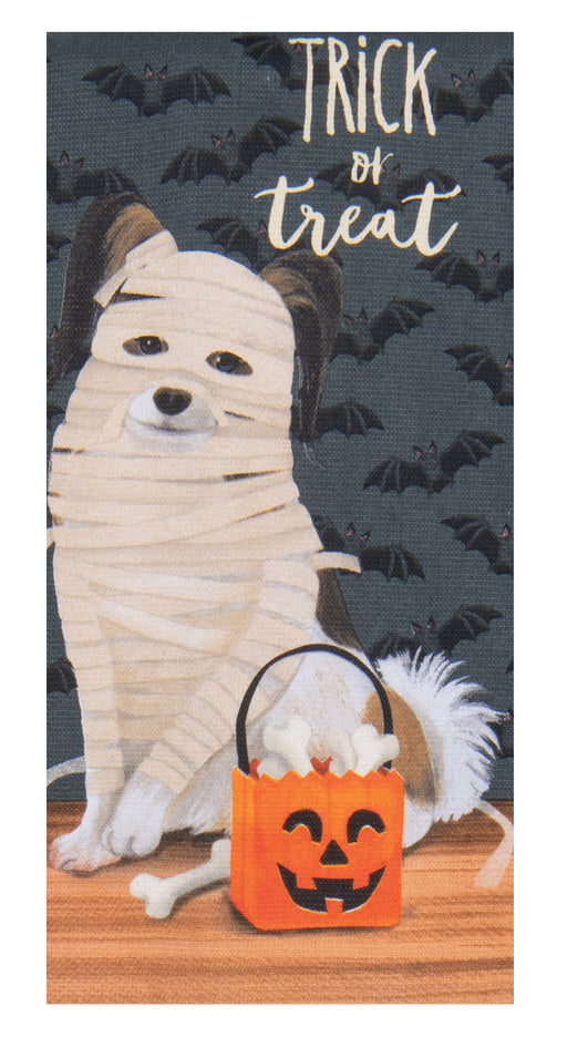 Halloween-themed towel with a mummy-wrapped dog and trick-or-treat bag on a dark background with bats.