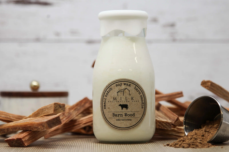 Milk bottle with a label on a wooden surface with cinnamon sticks