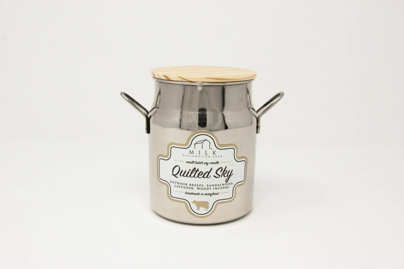 Metal milk churn with wooden lid on a white background
