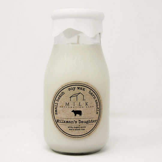 Candle in a glass jar with a label on a white background