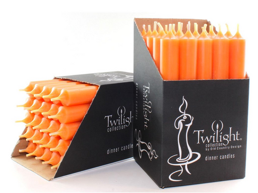 Orange candles in black Twilight packaging on a white background