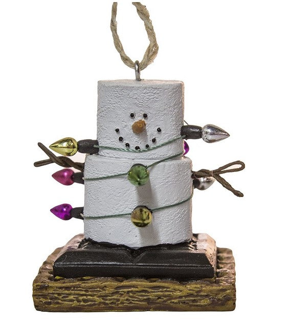 Decorative ornament shaped like a snowman made of marshmallows with candy decorations on a white background.