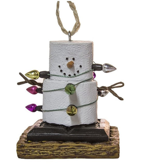 Decorative ornament shaped like a snowman made of marshmallows with candy decorations on a white background.