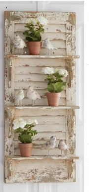 Decorative wall shelf with plants and birds on a white background
