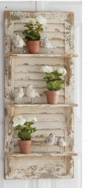 Decorative wall shelf with plants and birds on a white background