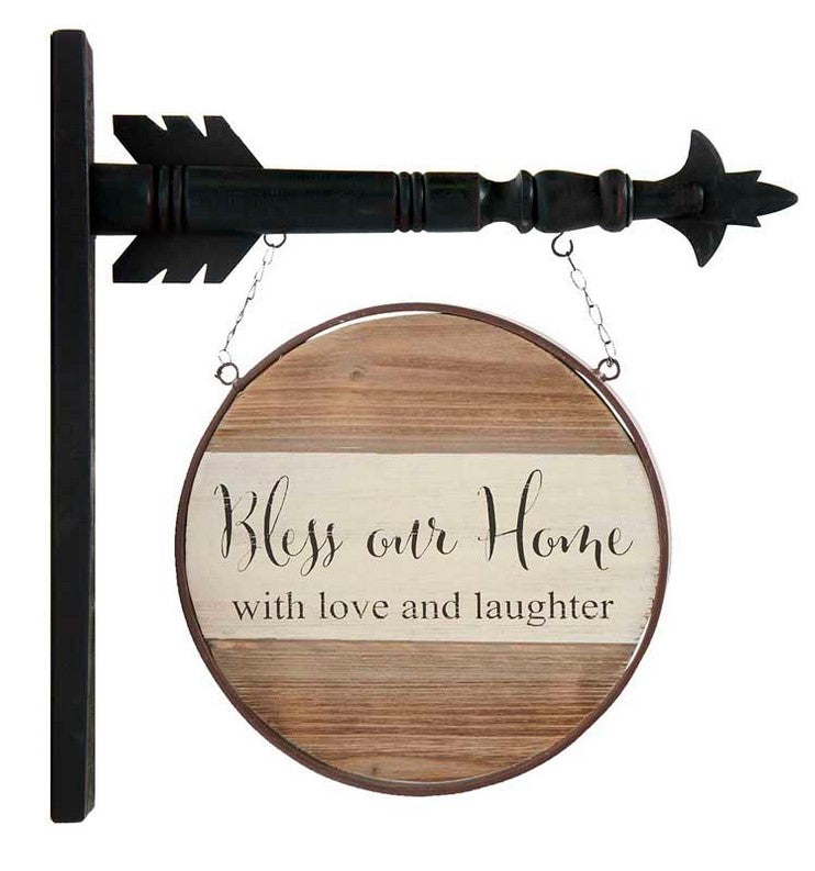 Decorative sign with 'Bless our Home with love and laughter' text on a wooden background.