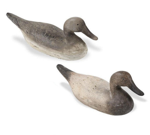 Two wooden duck decoys on a white background