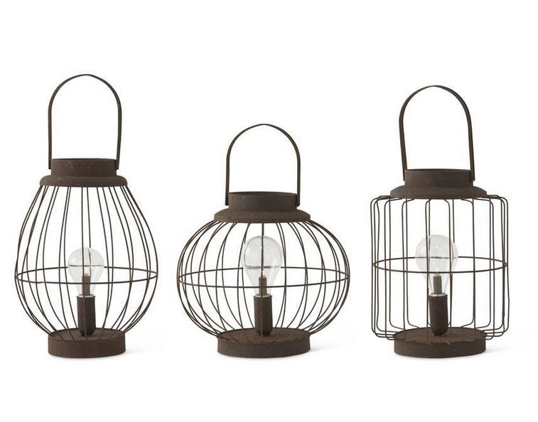 Three metal lanterns with wire cages on a white background