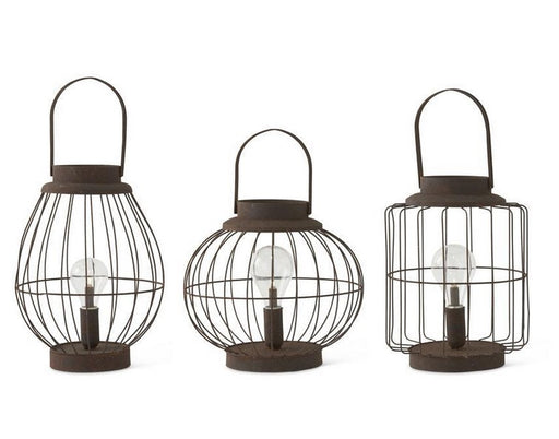 Three metal lanterns with wire cages on a white background