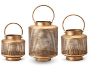 Three gold lanterns with mesh designs on a white background