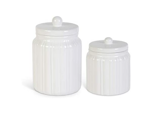 Two white ceramic jars with lids on a white background