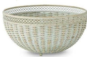 Two verdigris woven bowls with metal trim, one larger than the other, displayed on a surface with a floral patterned item in the background.