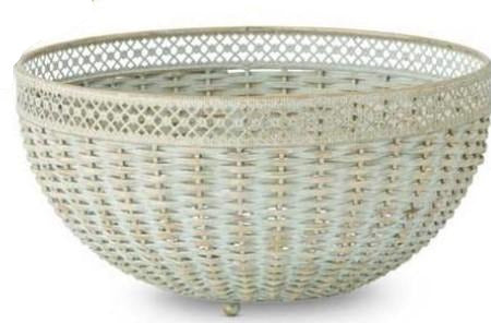 Two verdigris woven bowls with metal trim, one larger than the other, displayed on a surface with a floral patterned item in the background.