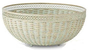 Two verdigris woven bowls with metal trim, one larger than the other, displayed on a surface with a floral patterned item in the background.