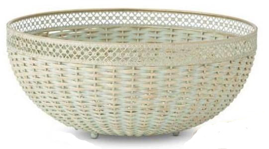 Two verdigris woven bowls with metal trim, one larger than the other, displayed on a surface with a floral patterned item in the background.