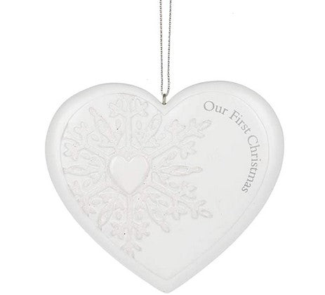 Heart-shaped ornament with 'Our First Christmas' text on a white background