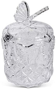 Clear glass apple-shaped container with a lid on a white background