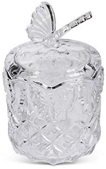 Clear glass apple-shaped container with a lid on a white background
