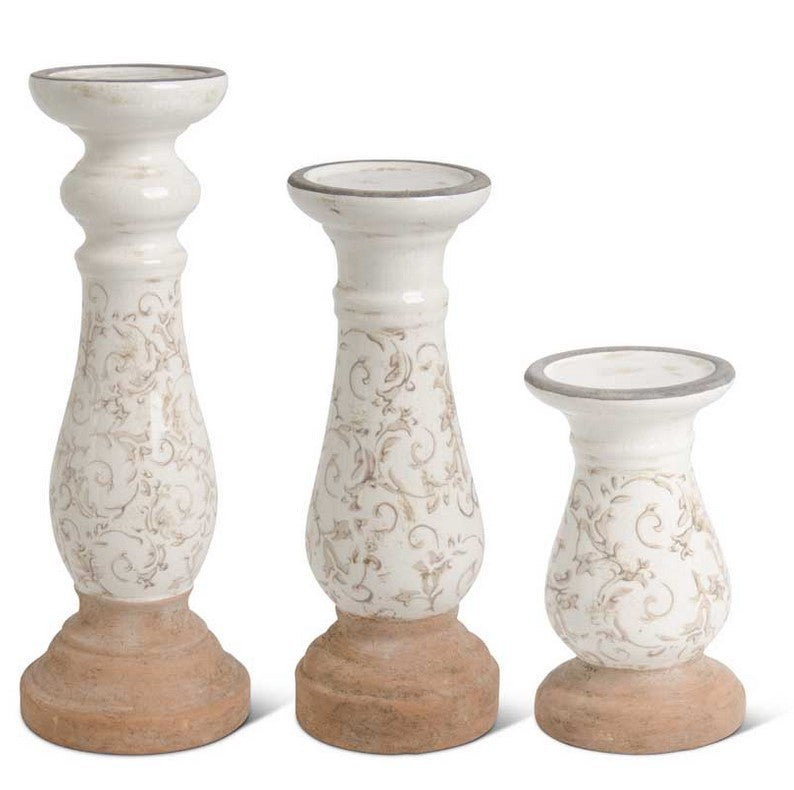 Three decorative candle holders with white and brown patterns on a white background