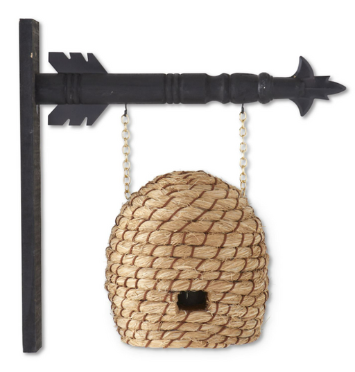 Decorative birdhouse shaped like a pine cone attached to a black metal arrow on a white background