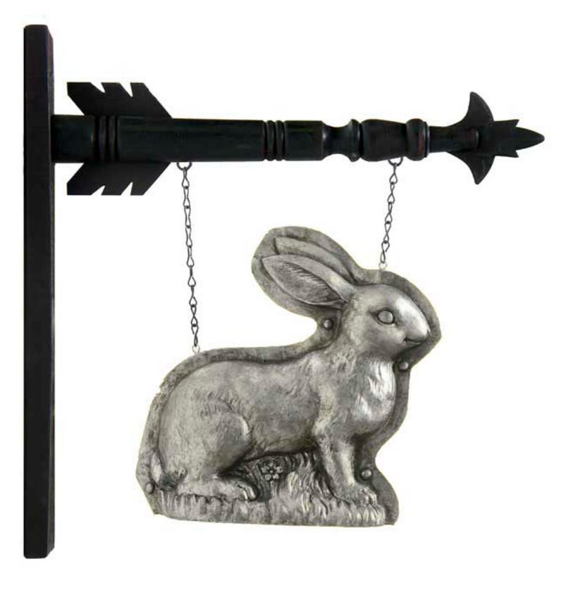 Decorative metal rabbit hanging from a black arrow-shaped wall mount on a white background