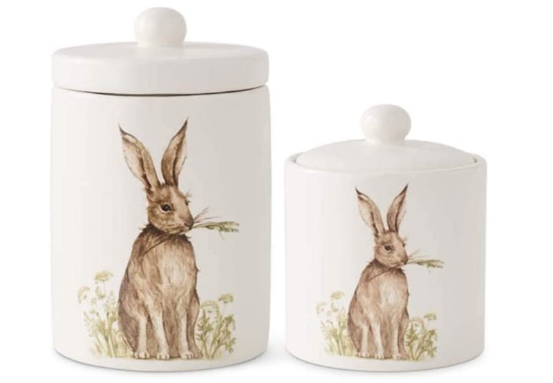 Two ceramic jars with rabbit illustrations on a white background