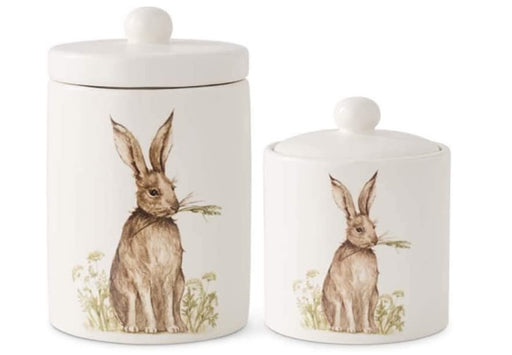 Two ceramic jars with rabbit illustrations on a white background