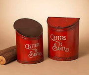Two red cylindrical mailboxes with 'Letters to Santa' text on a beige background