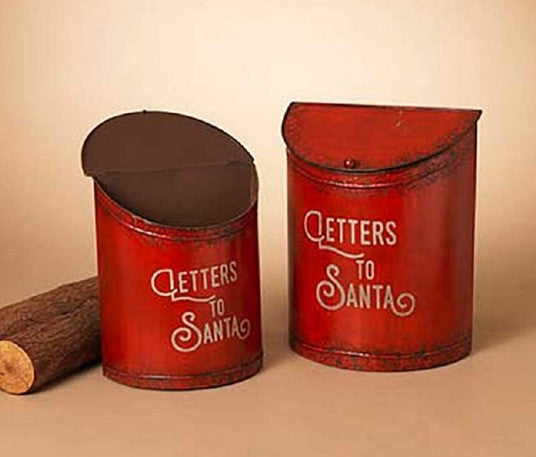 Two red cylindrical mailboxes with 'Letters to Santa' text on a beige background