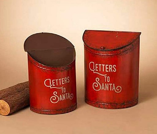 Two red cylindrical mailboxes with 'Letters to Santa' text on a beige background
