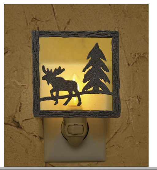 Decorative night light with moose and tree design on a textured wall.