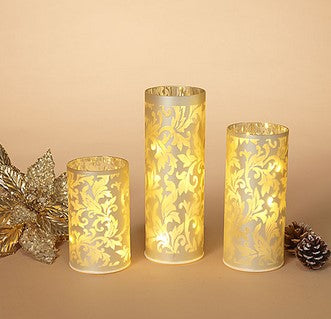 Three decorative candles with floral patterns on a beige background